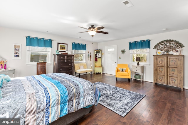 bedroom featuring visible vents, ceiling fan, and wood finished floors