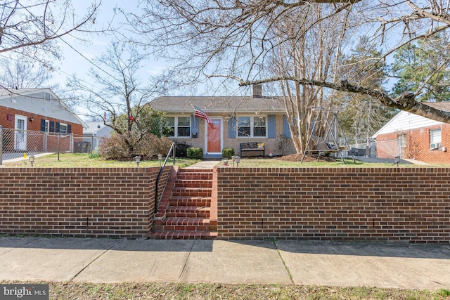 ranch-style home featuring brick siding, a chimney, and fence