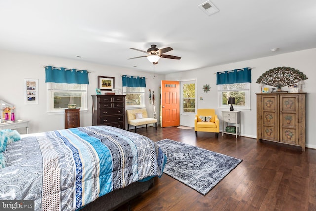 bedroom featuring visible vents, wood finished floors, and a ceiling fan