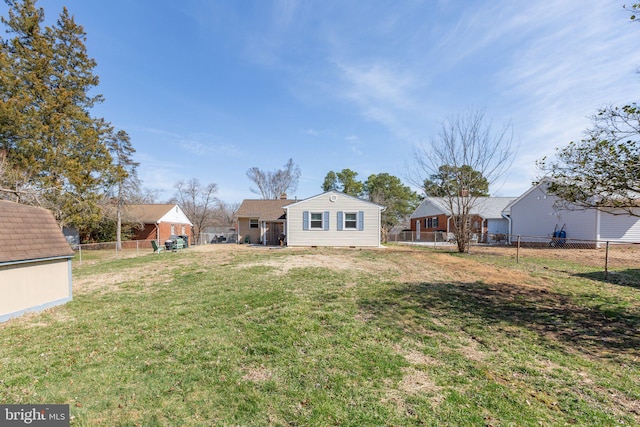 view of yard featuring an outbuilding and fence