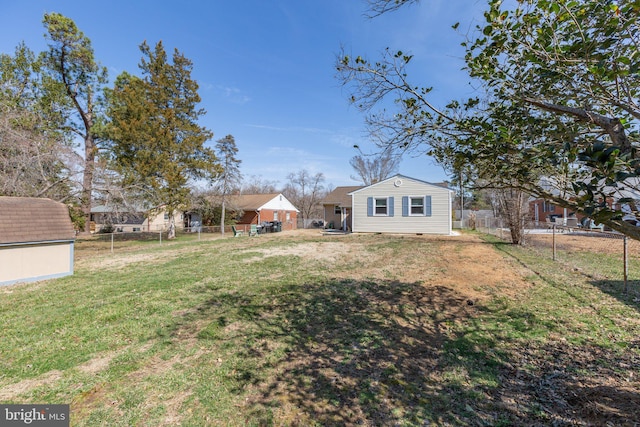 view of yard featuring an outdoor structure, a storage shed, and a fenced backyard