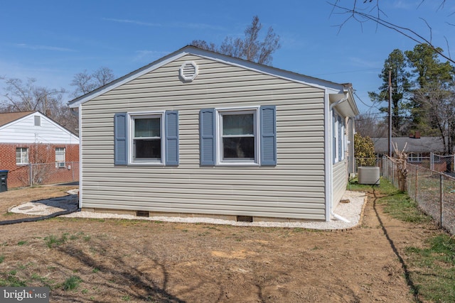 view of home's exterior featuring crawl space, central AC unit, and fence