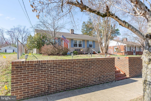 ranch-style home with brick siding and a chimney