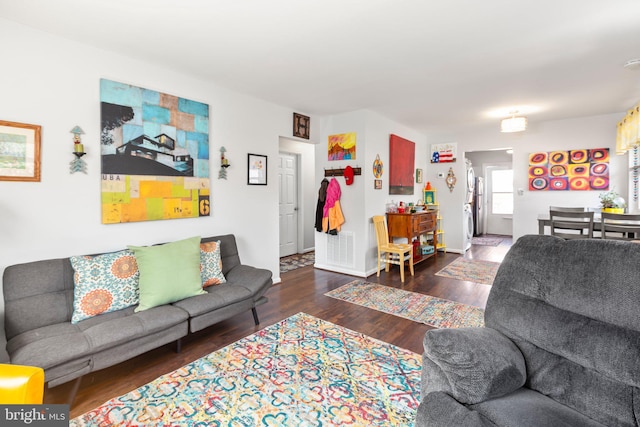 living area with wood finished floors and baseboards