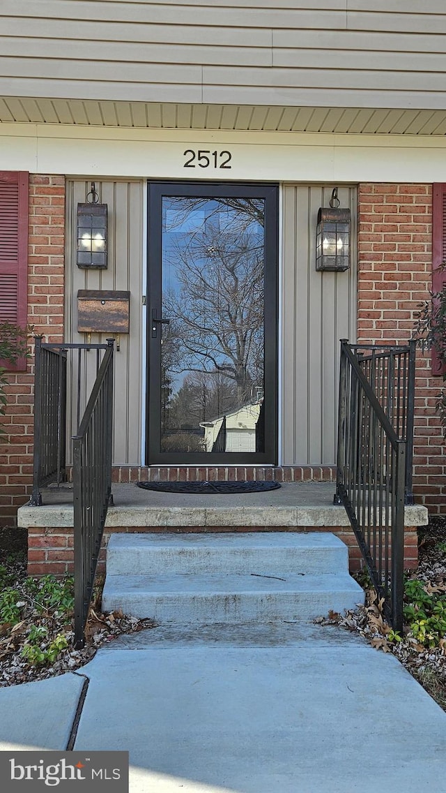 property entrance with brick siding