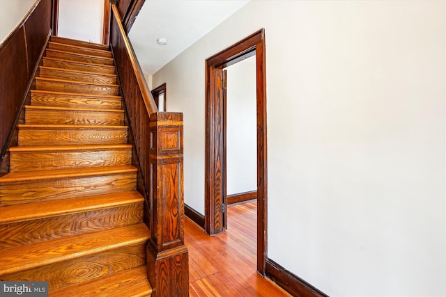 stairs featuring baseboards and hardwood / wood-style flooring