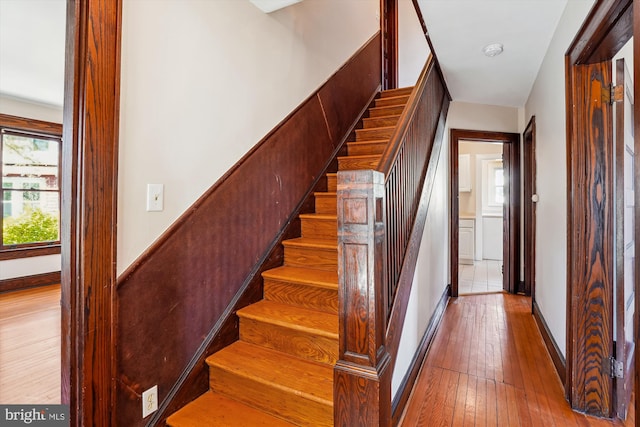 staircase featuring hardwood / wood-style flooring and baseboards