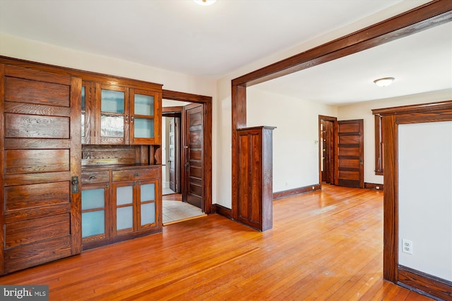 empty room featuring light wood-style flooring and baseboards