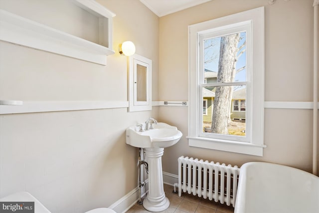 bathroom featuring tile patterned flooring, radiator heating unit, and baseboards