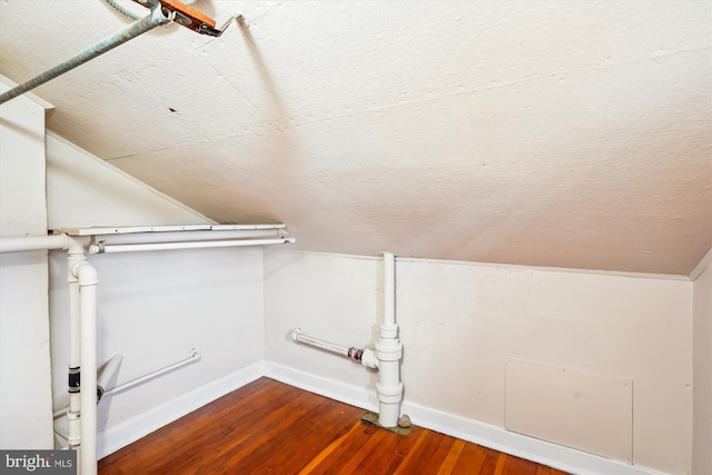 interior space featuring lofted ceiling and wood finished floors