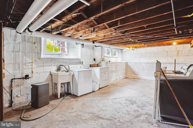 basement featuring a sink and washer and clothes dryer