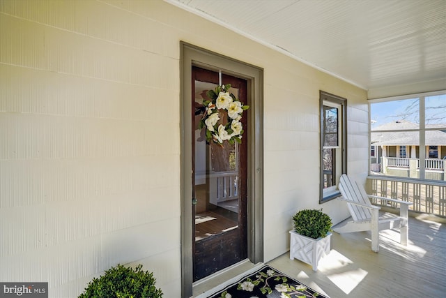 view of exterior entry featuring a porch