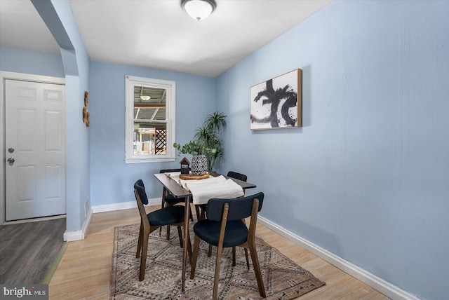 dining room with light wood-style flooring and baseboards