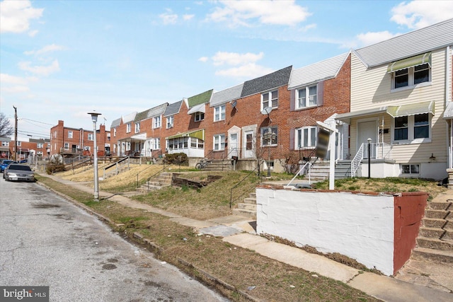 view of property with brick siding and a residential view