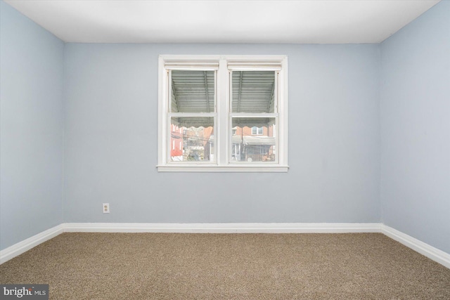 unfurnished room featuring baseboards and carpet floors