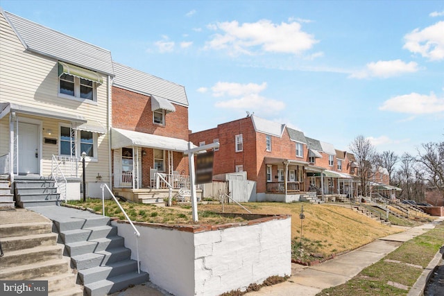 view of front of home with a residential view and brick siding