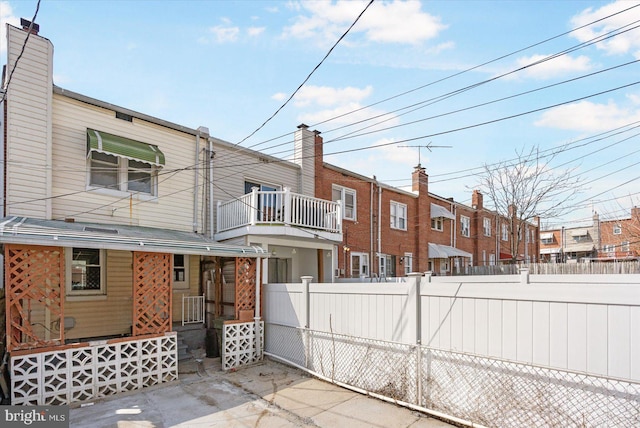 rear view of house with fence