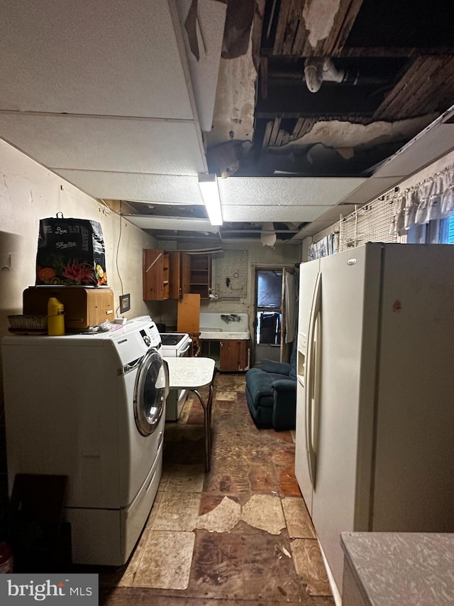 interior space with a sink, stone finish flooring, and laundry area