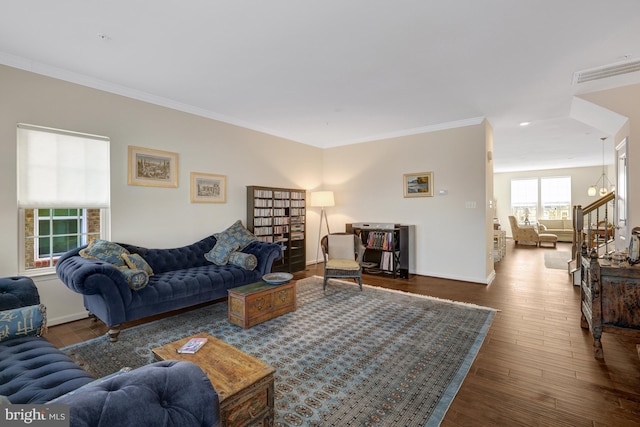 living room featuring visible vents, baseboards, stairs, ornamental molding, and wood finished floors