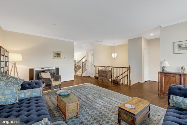 living area featuring wood finished floors, recessed lighting, stairway, crown molding, and baseboards