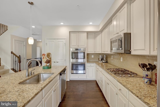 kitchen featuring backsplash, recessed lighting, dark wood-style floors, stainless steel appliances, and a sink