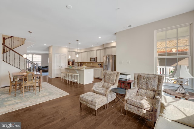 living room featuring stairway, visible vents, recessed lighting, dark wood-style flooring, and a notable chandelier