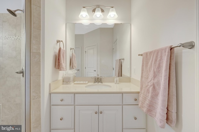 full bathroom with vanity and tiled shower