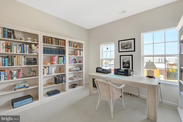 office area with visible vents, baseboards, a healthy amount of sunlight, and carpet flooring