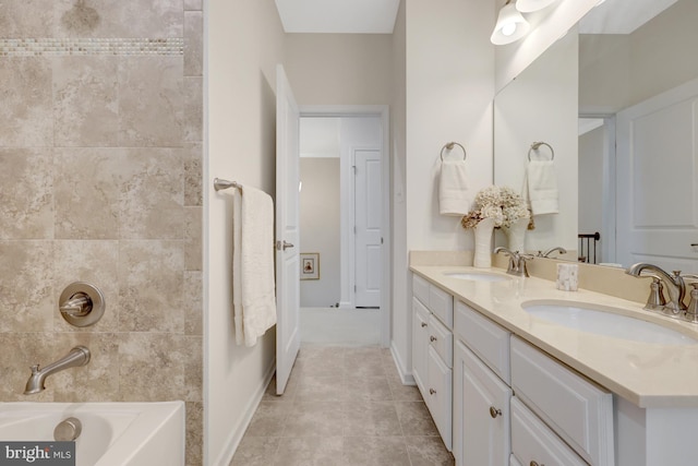 bathroom with double vanity, shower / bathing tub combination, tile patterned floors, and a sink