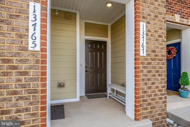 entrance to property with brick siding