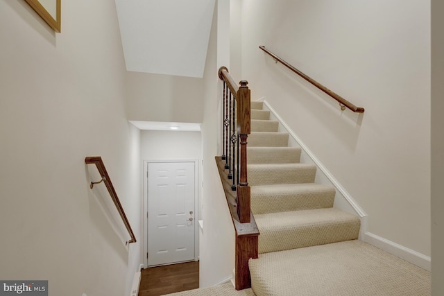 staircase featuring baseboards