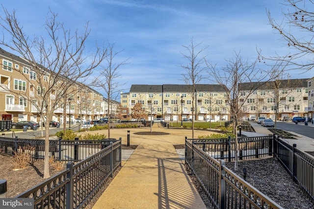 surrounding community with a residential view and fence