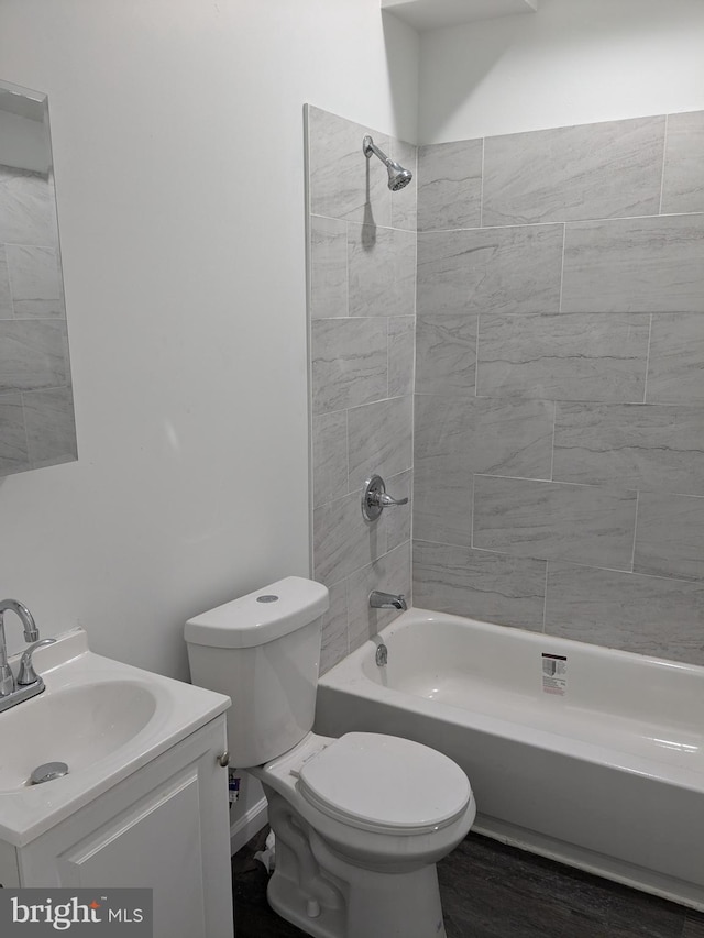 bathroom featuring vanity, shower / bathing tub combination, and toilet