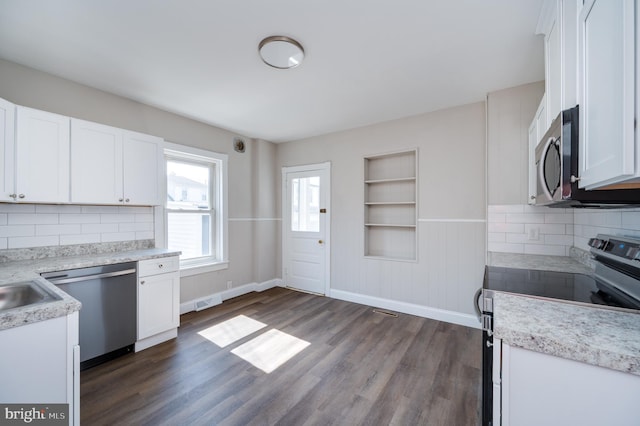 kitchen featuring white cabinetry, light countertops, dark wood-style flooring, and stainless steel appliances