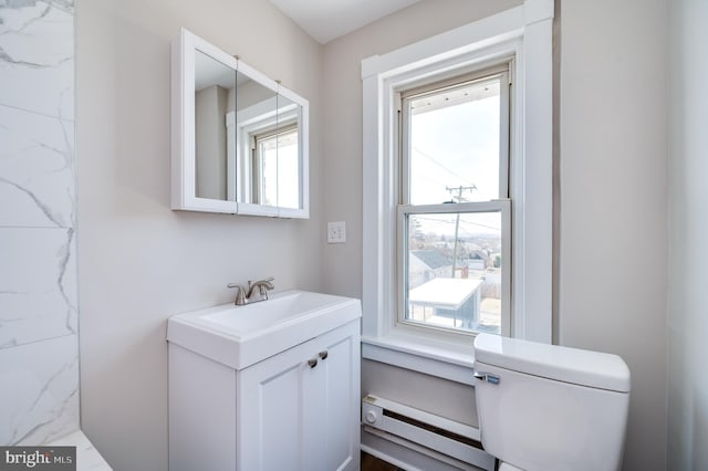 bathroom with vanity, toilet, and a baseboard radiator