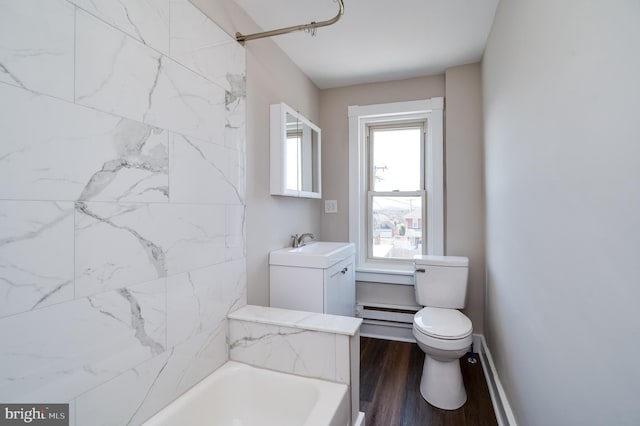 full bathroom featuring vanity, wood finished floors, bathtub / shower combination, toilet, and baseboard heating