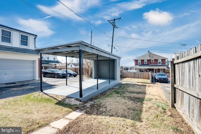 view of yard featuring fence and a garage