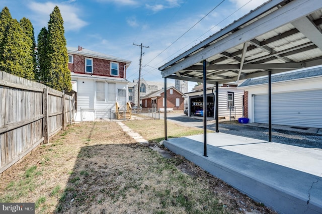 view of yard featuring an outdoor structure and fence