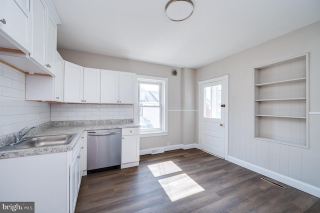 kitchen with visible vents, a sink, light countertops, dishwasher, and dark wood-style flooring