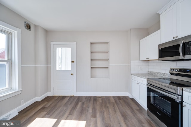 kitchen featuring baseboards, visible vents, dark wood finished floors, white cabinets, and appliances with stainless steel finishes