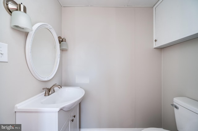 bathroom featuring toilet and vanity