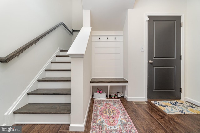 staircase with wood finished floors and baseboards