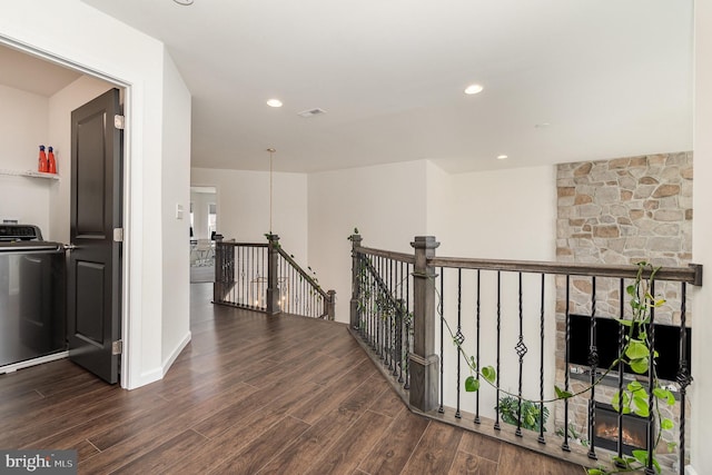 corridor with recessed lighting, an upstairs landing, wood finished floors, and washer / clothes dryer