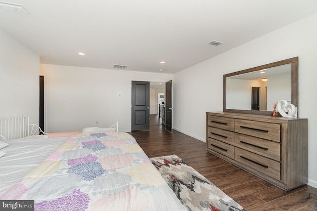 bedroom featuring dark wood finished floors, recessed lighting, and visible vents