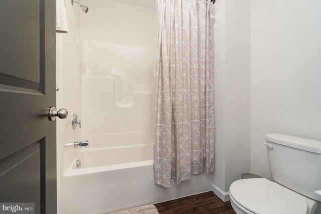 bathroom with shower / bathtub combination with curtain, baseboards, toilet, and wood finished floors