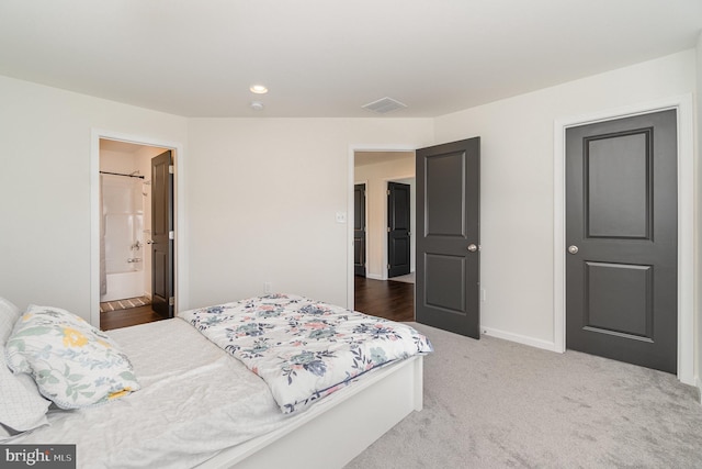 carpeted bedroom with recessed lighting, visible vents, connected bathroom, and baseboards