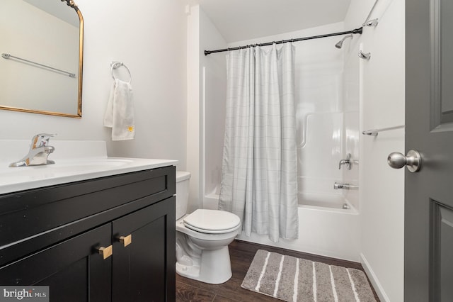 bathroom featuring toilet, shower / bath combo with shower curtain, vanity, and wood finished floors