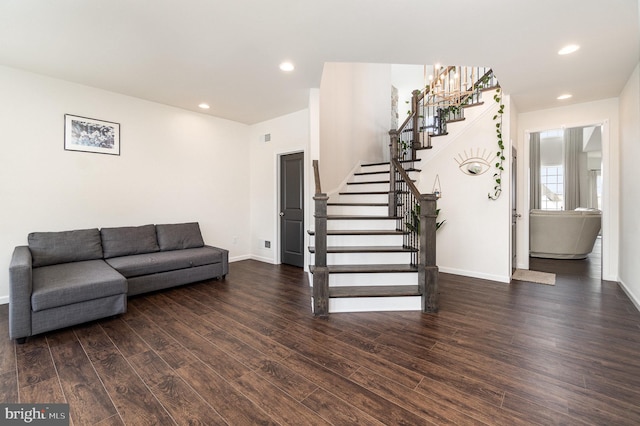 living area featuring stairs, recessed lighting, dark wood finished floors, and baseboards