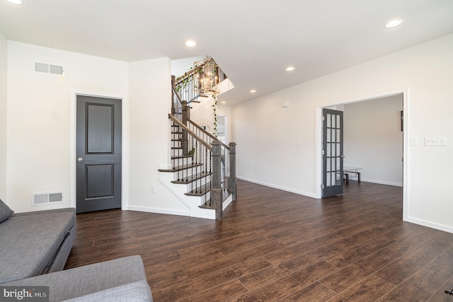 living area with recessed lighting, visible vents, wood finished floors, and stairs