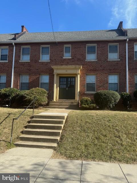 view of property with brick siding